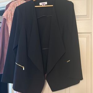 Calvin Klein cropped jacket with gold zippered pockets.